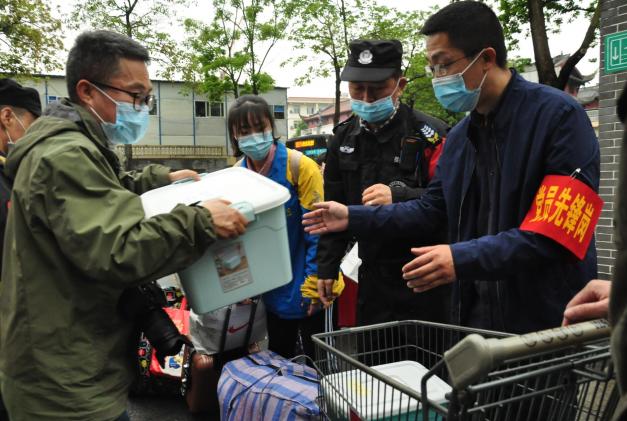 教师志愿者帮助同学搬运行李